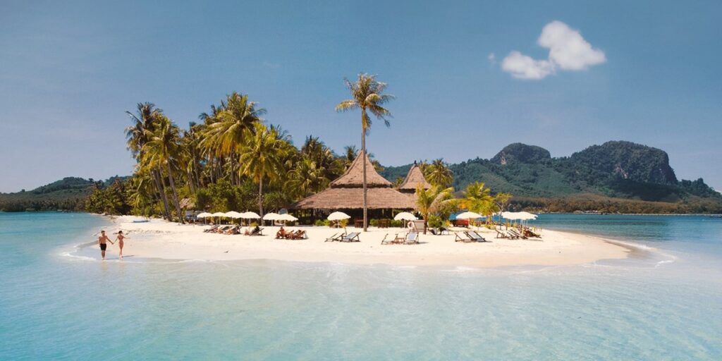 Couple running on the beach at Koh Mook, Thailand