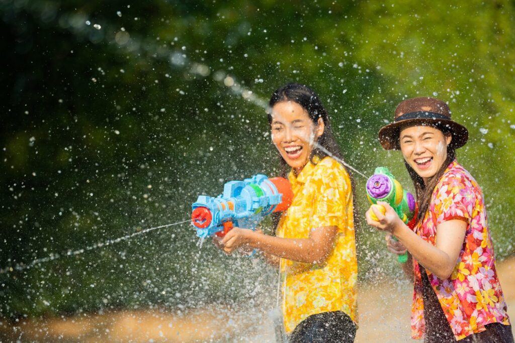 image of 2 people playing water gun