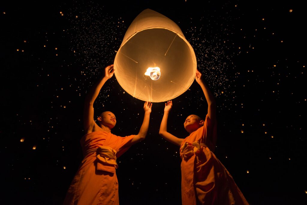 image of 2 people holding a lantern